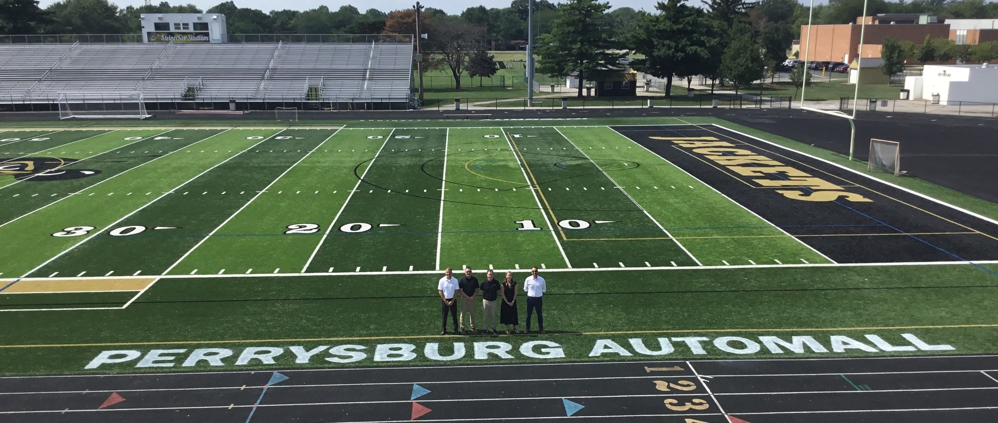 Justin Miller – Commercial Truck Manager, Matt Cunningham – Buick/GMC General Manager, Connie Cronin – Controller, Richard Cronin – President, Ryan Ort – Perrysburg Automall General Manager on the field at Steinecker Stadium
